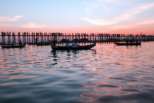 U Bein Bridge at sunset in Mandalay Myanmar. The 1.2-kilometre bridge was built around 1850 and is believed to be the oldest and longest teakwood bridge in the world