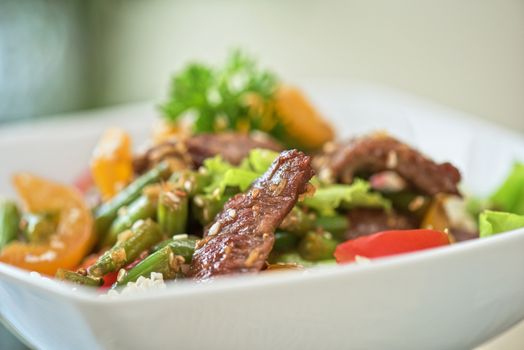 Warm salad with veal closeup