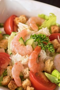 Caesar shrimp salad with cheese and arugula