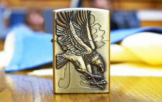 A cigarette lighter with eagle carved on its side