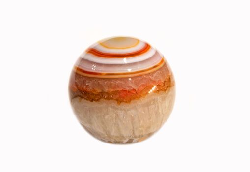 Polished striped natural agate ball on white background