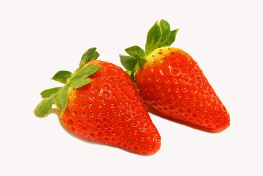 Two red strawberries closeup over white background