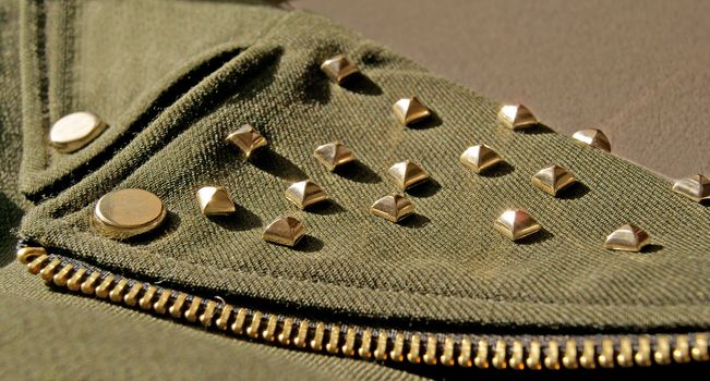 Woman Jacket detail with golden metal spikes, swag style 