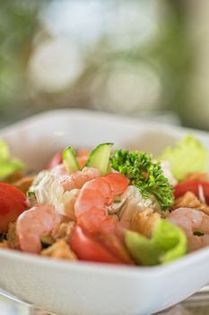 Caesar shrimp salad with cheese and arugula