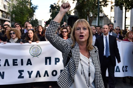 GREECE, Athens: A Greek woman leads thousands of striking lawyers, along with engineers, doctors, and pharmacists, in a march to parliament in Athens, Greece on January 14, 2016 as they rally against planned reforms to their pension system. Protests reportedly follow proposals for steep increases in their insurance contributions.