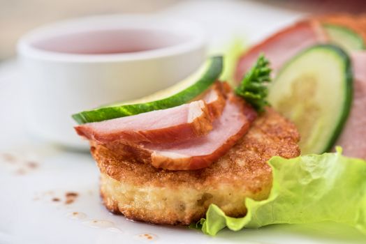 pancakes with ham and cucumber with tomato sauce and lettuce