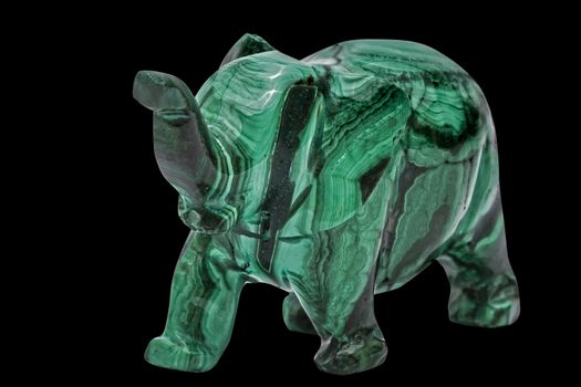 Elephant figurine from malachite, isolated on black background, with clipping path
