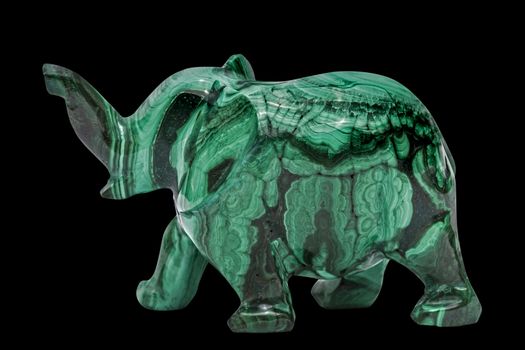 Elephant figurine from malachite, isolated on black background, with clipping path