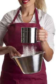 woman in an apron with a sieve