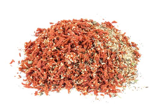 Heap of dried tomato with garlic and basil spice isolated on white background