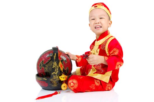 Chinese young boy in traditional Chinese cheongsam , isolated on white background