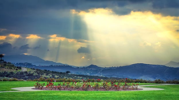 ray of sun over the mountain with cloudy sky