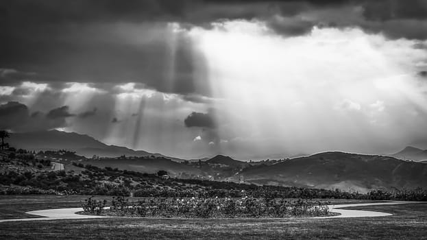 ray of sun over the mountain in black and white