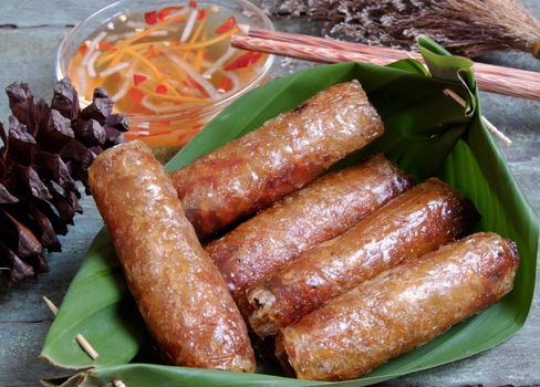 Vietnamese food, spring roll or cha gio, a delicious fried food with cylinder shape, eat with bun, salad and fish sauce, this also rich calories, cholesterol, fatty food, popular Vietnam eating