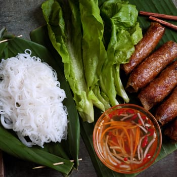 Vietnamese food, spring roll or cha gio, a delicious fried food with cylinder shape, eat with bun, salad and fish sauce, this also rich calories, cholesterol, fatty food, popular Vietnam eating