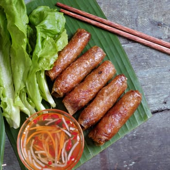 Vietnamese food, spring roll or cha gio, a delicious fried food with cylinder shape, eat with bun, salad and fish sauce, this also rich calories, cholesterol, fatty food, popular Vietnam eating