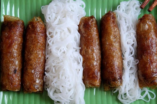 Vietnamese food, spring roll or cha gio, a delicious fried food with cylinder shape, eat with bun, salad and fish sauce, this also rich calories, cholesterol, fatty food, popular Vietnam eating