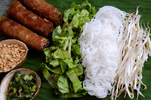 Vietnamese food, spring roll or cha gio, a delicious fried food with cylinder shape, eat with bun, salad and fish sauce, this also rich calories, cholesterol, fatty food, popular Vietnam eating