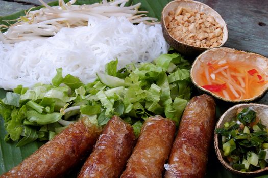Vietnamese food, spring roll or cha gio, a delicious fried food with cylinder shape, eat with bun, salad and fish sauce, this also rich calories, cholesterol, fatty food, popular Vietnam eating