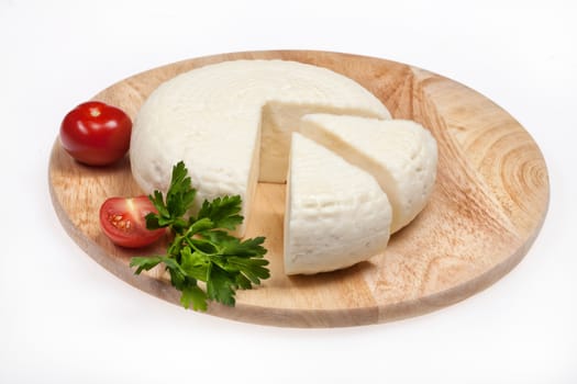 Piece of national caucasian cheese on a wooden table