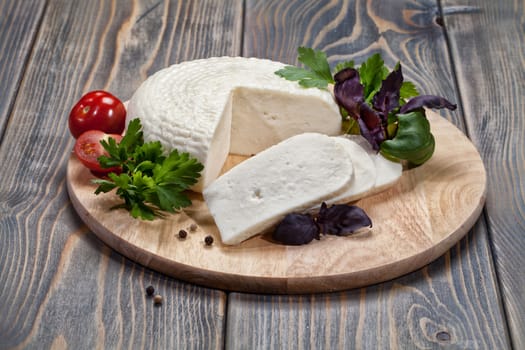 Piece of national caucasian cheese on a wooden table