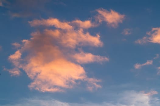 Autumn red gray clouds in the blue sky during the autumn sunset