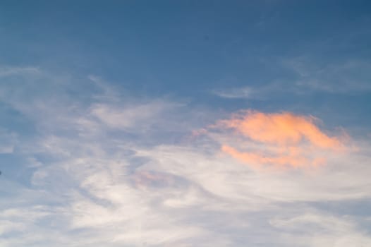 Autumn red gray clouds in the blue sky during the autumn sunset