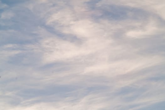 Autumn red gray clouds in the blue sky during the autumn sunset