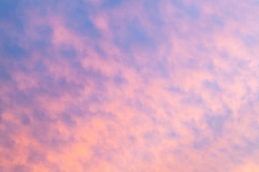 Autumn red gray clouds in the blue sky during the autumn sunset