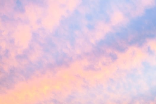 Autumn red gray clouds in the blue sky during the autumn sunset