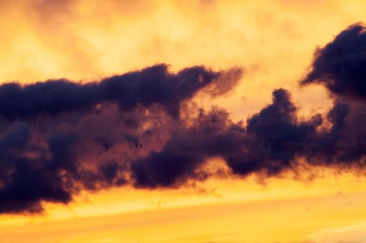 Beautiful fiery clouds at a sunset in the summer afternoon