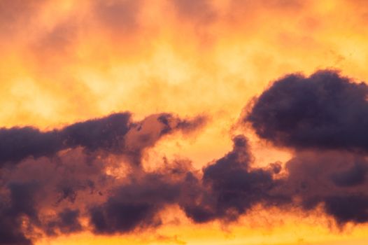 Beautiful fiery clouds at a sunset in the summer afternoon