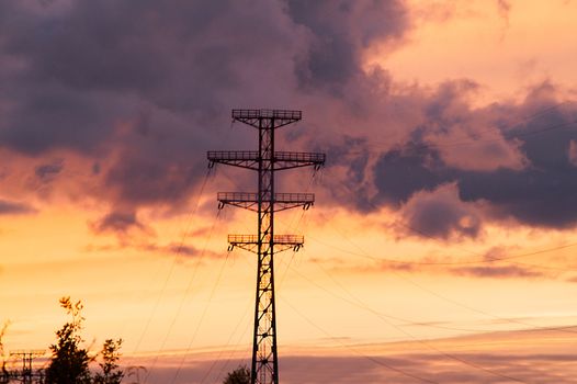 Bearing high-voltage power lines on a red sunset