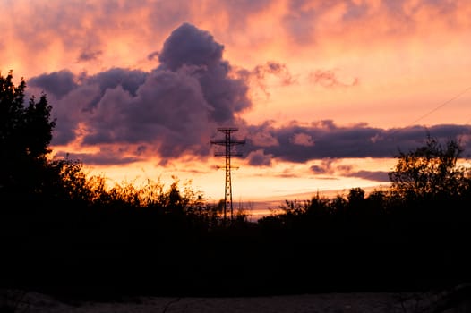 Bearing high-voltage power lines on a red sunset