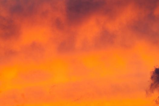 Autumn red gray clouds in the blue sky during the autumn sunset