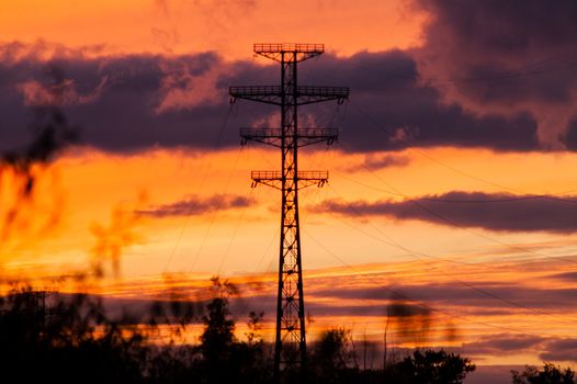 Bearing high-voltage power lines on a red sunset