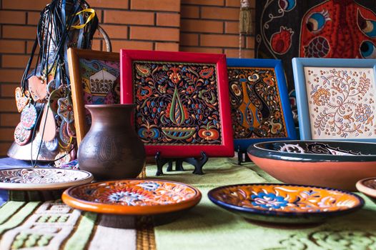 set of dishes by hand on the background of a jug