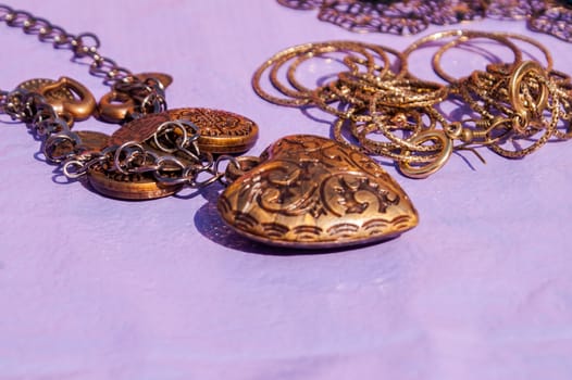 Different bright, multi-colored jewelry of handwork in a sunlight