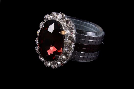 A luxurious tissue holder made of silver and studded with a red gemstone