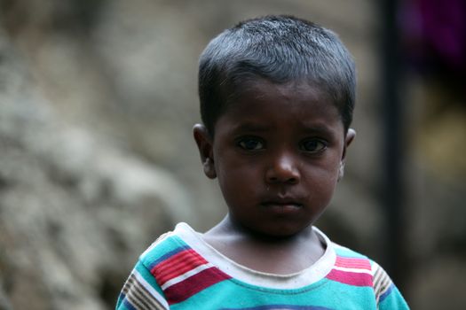 A portrait of a poor boy from India in his unfortunate condition.