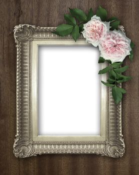 Vintage rose and blank photo frame on old wooden background