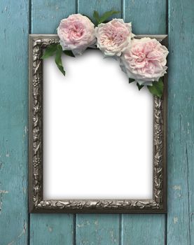 Vintage rose and blank photo frame on old wooden background