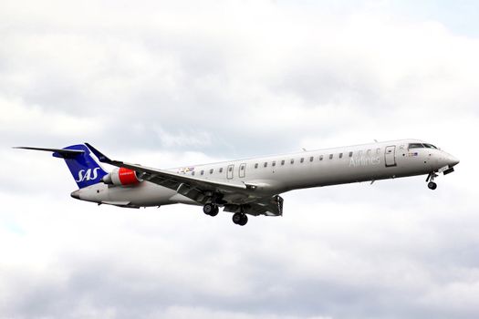 BERLIN, GERMANY - AUGUST 17, 2014: Scandinavian Airlines Bombardier CRJ-900ER NG arrives to the Tegel International Airport.