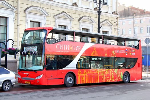 SAINT PETERSBURG, RUSSIA - MAY 25, 2013: Red UNVI Urbis city sightseeing bus at the city street.