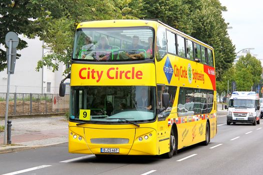 BERLIN, GERMANY - SEPTEMBER 10, 2013: Yellow UNVI Urbis city sightseeing bus at the city street.