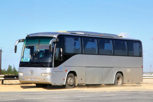 NOVYY URENGOY, RUSSIA - JUNE 30, 2013: Grey Higer KLQ6109Q interurban coach at the dusty interurban road.