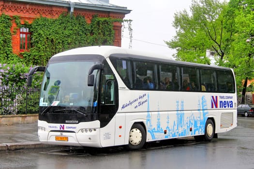 SAINT PETERSBURG, RUSSIA - MAY 25, 2013: White Neoplan N2216SHD Tourliner interurban coach at the city street.