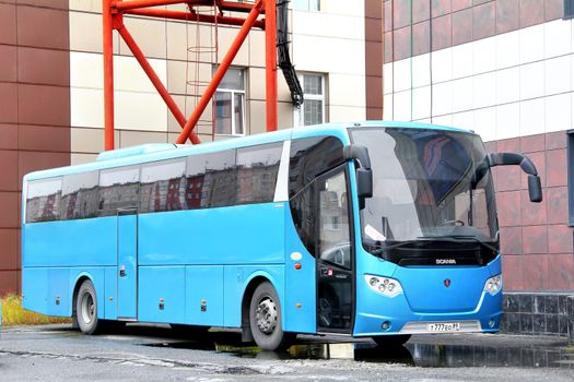 NOVYY URENGOY, RUSSIA - SEPTEMBER 1, 2012: Cyan Scania OmniExpress 340 interurban coach at the city street.