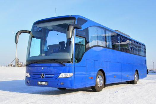 NOVYY URENGOY, RUSSIA - MARCH 8, 2014: Blue Mercedes-Benz O350RHD Tourismo interurban coach at the city street.
