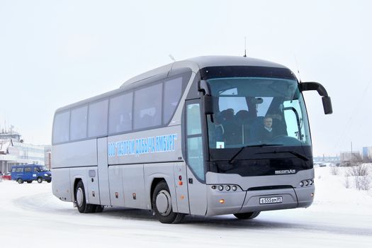 NOVYY URENGOY, RUSSIA - FEBRUARY 9, 2013: Grey Neoplan N2216SHD Tourliner interurban coach at the city street.